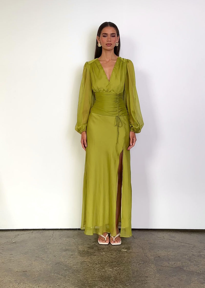 Video: Moonstruck Maxi Dress in Chartreuse with a deep V-neckline, softly gathered bodice, sheer long blouson sleeves with elasticated cuffs, ruched waist with adjustable side tie detailing and a flowing maxi-length silhouette with a thigh-high side split.