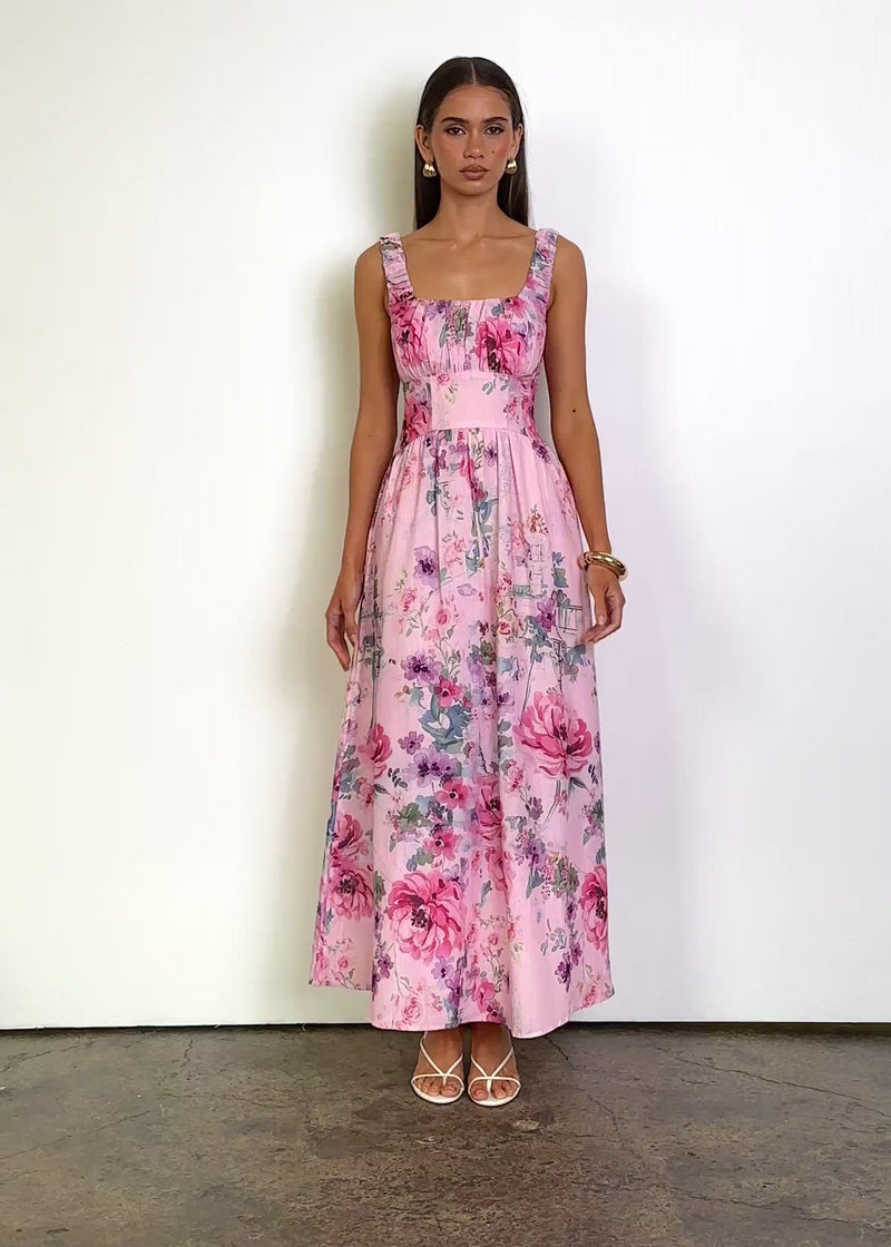 Video: Brylee Maxi Dress in Bubblegum Blossom with a square neckline, wide gathered straps and a softly ruched bust, featuring a fitted waistband and flowing A-line maxi silhouette in a vibrant floral print.