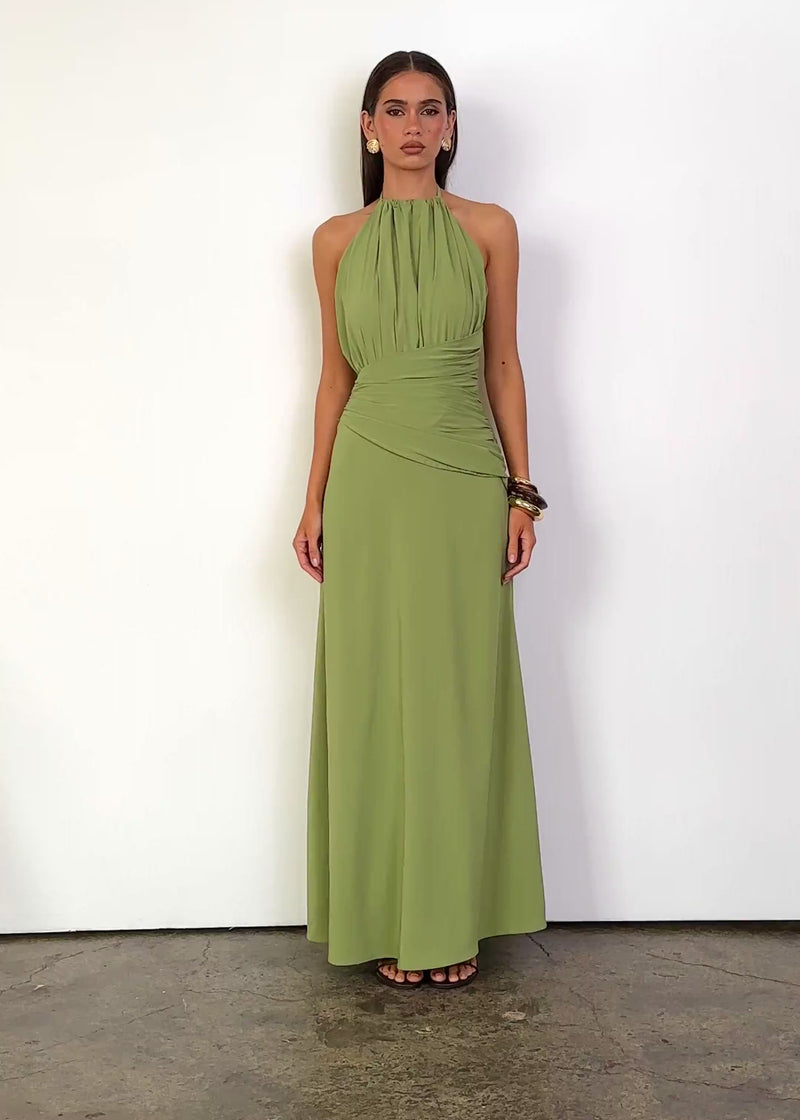 Video: Tianne Halter Maxi Dress in Matcha with a gathered high halter neckline, sleeveless design and softly draped bodice, featuring a fitted ruched wrap-style waist that flows into a relaxed A-line maxi-length hem.