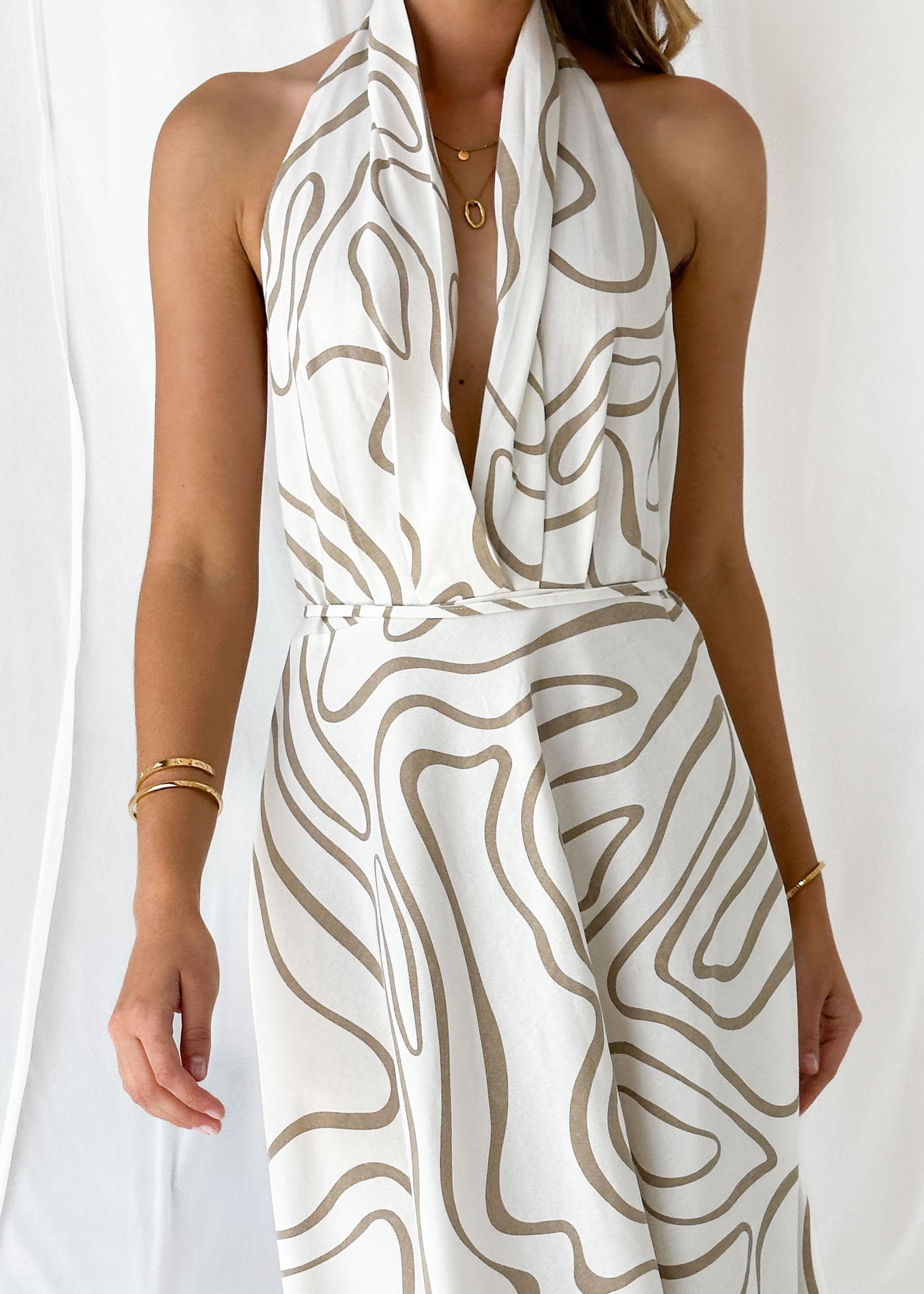 White halter top flowy maxi dress with gold necklace